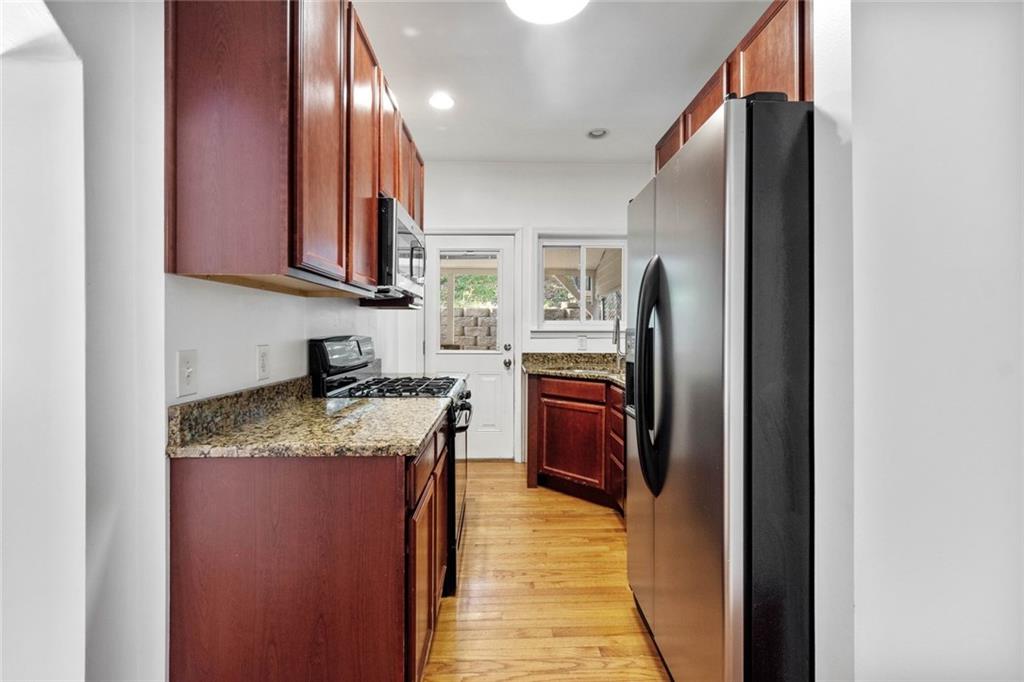 324 Merrimac Street Pittsburgh, PA 15211 - Photo 14 of 37 a kitchen with stainless steel appliances granite countertop a refrigerator a stove and a sink