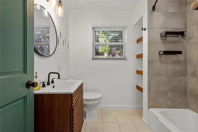 a bathroom with a toilet a sink and a mirror