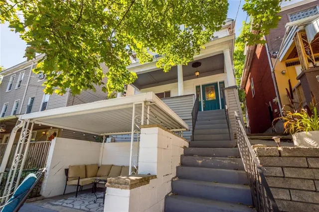 a view of a house with a large tree
