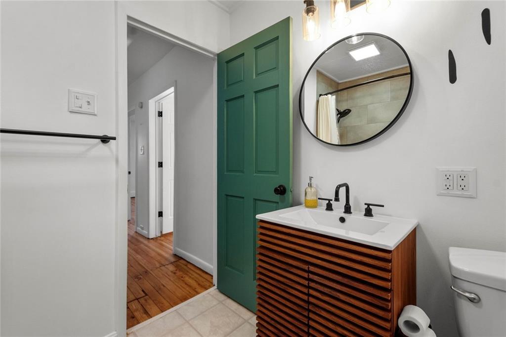 324 Merrimac Street Pittsburgh, PA 15211 - Photo 21 of 37 a bathroom with a sink a mirror and a toilet
