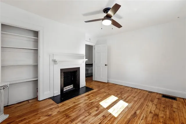 a view of empty room with fan and window