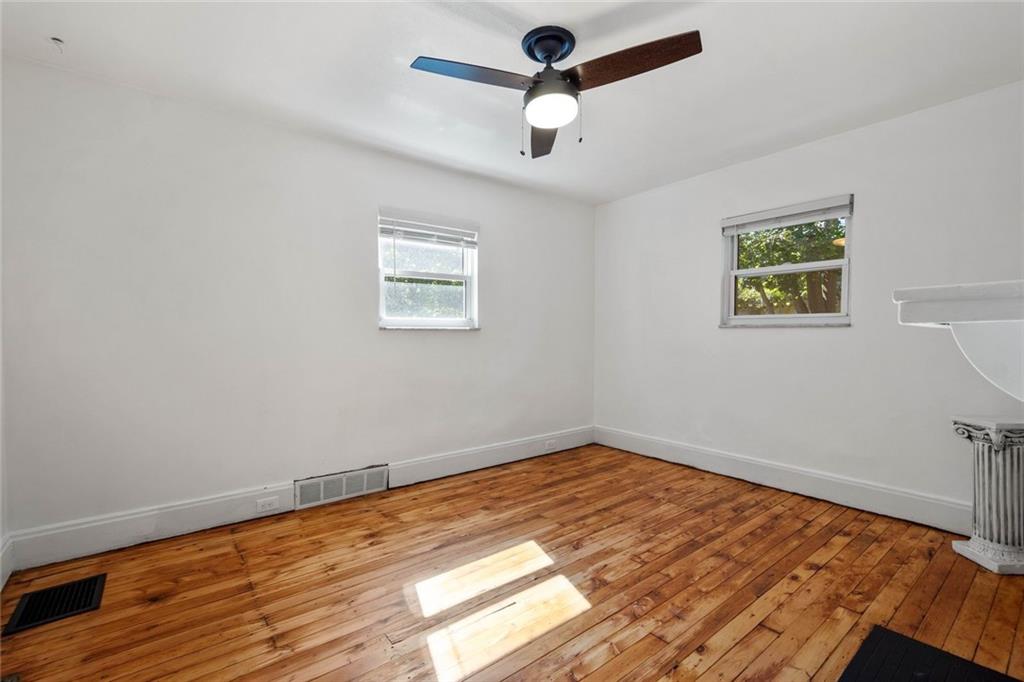 324 Merrimac Street Pittsburgh, PA 15211 - Photo 24 of 37 a view of room with hardwood floor and ceiling fan
