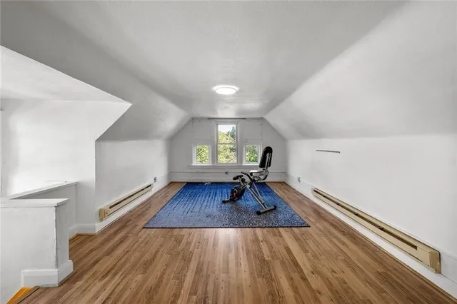 a view of a white house next to a yard