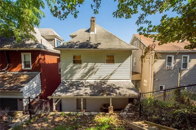 an aerial view of residential house with green space