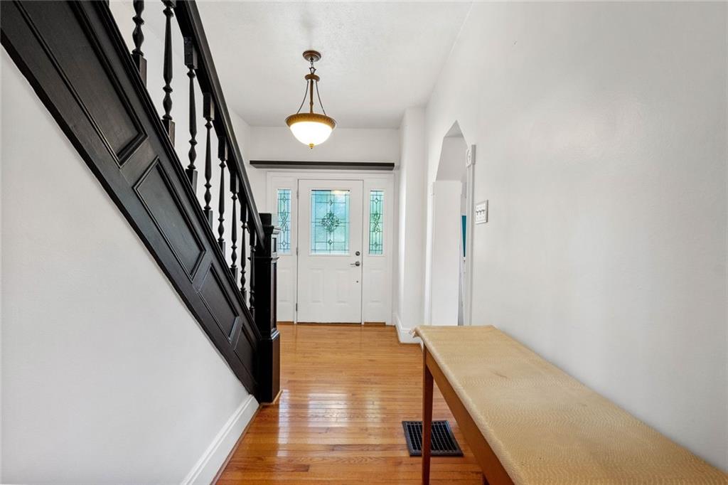 324 Merrimac Street Pittsburgh, PA 15211 - Photo 5 of 37 a view of a hallway with wooden floor and staircase