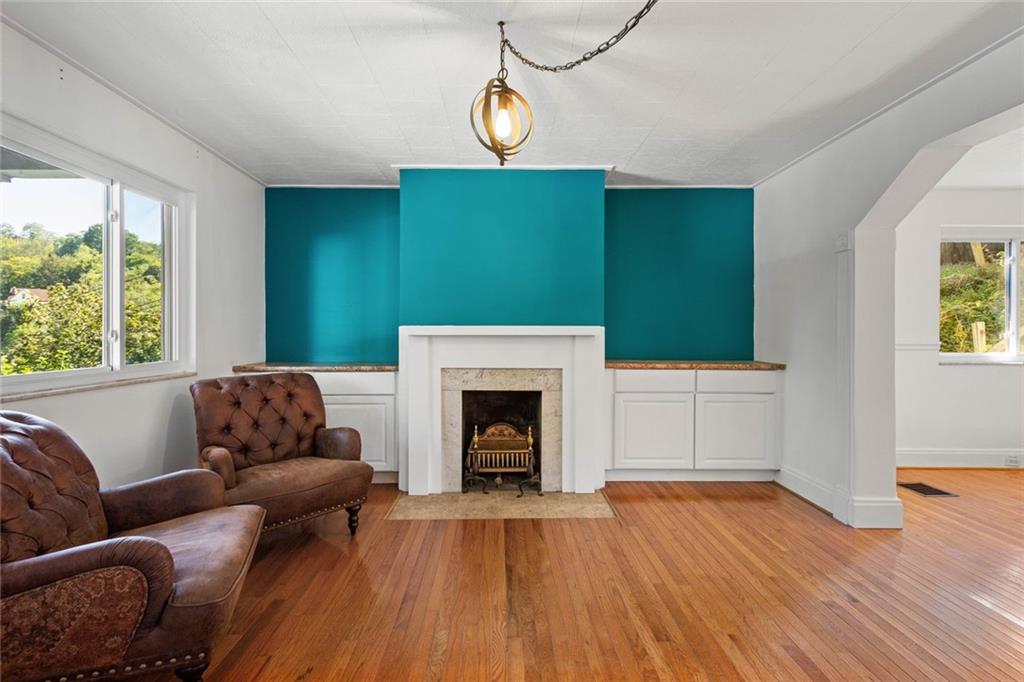 324 Merrimac Street Pittsburgh, PA 15211 - Photo 7 of 37 a living room with furniture and a fireplace