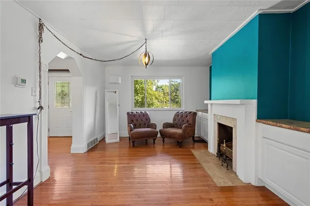 a living room with furniture fireplace and window