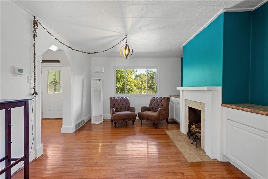 324 Merrimac Street Pittsburgh, PA 15211 - Photo 9 of 37 a living room with furniture fireplace and window