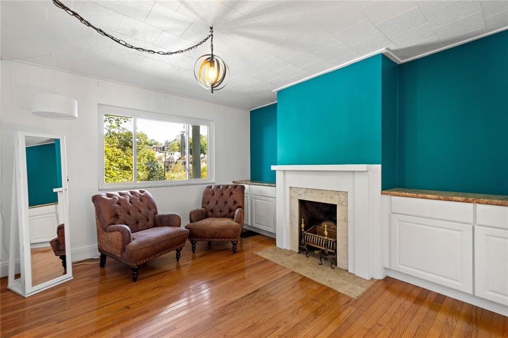 324 Merrimac Street Pittsburgh, PA 15211 - Photo 10 of 37 a living room with furniture and a fireplace