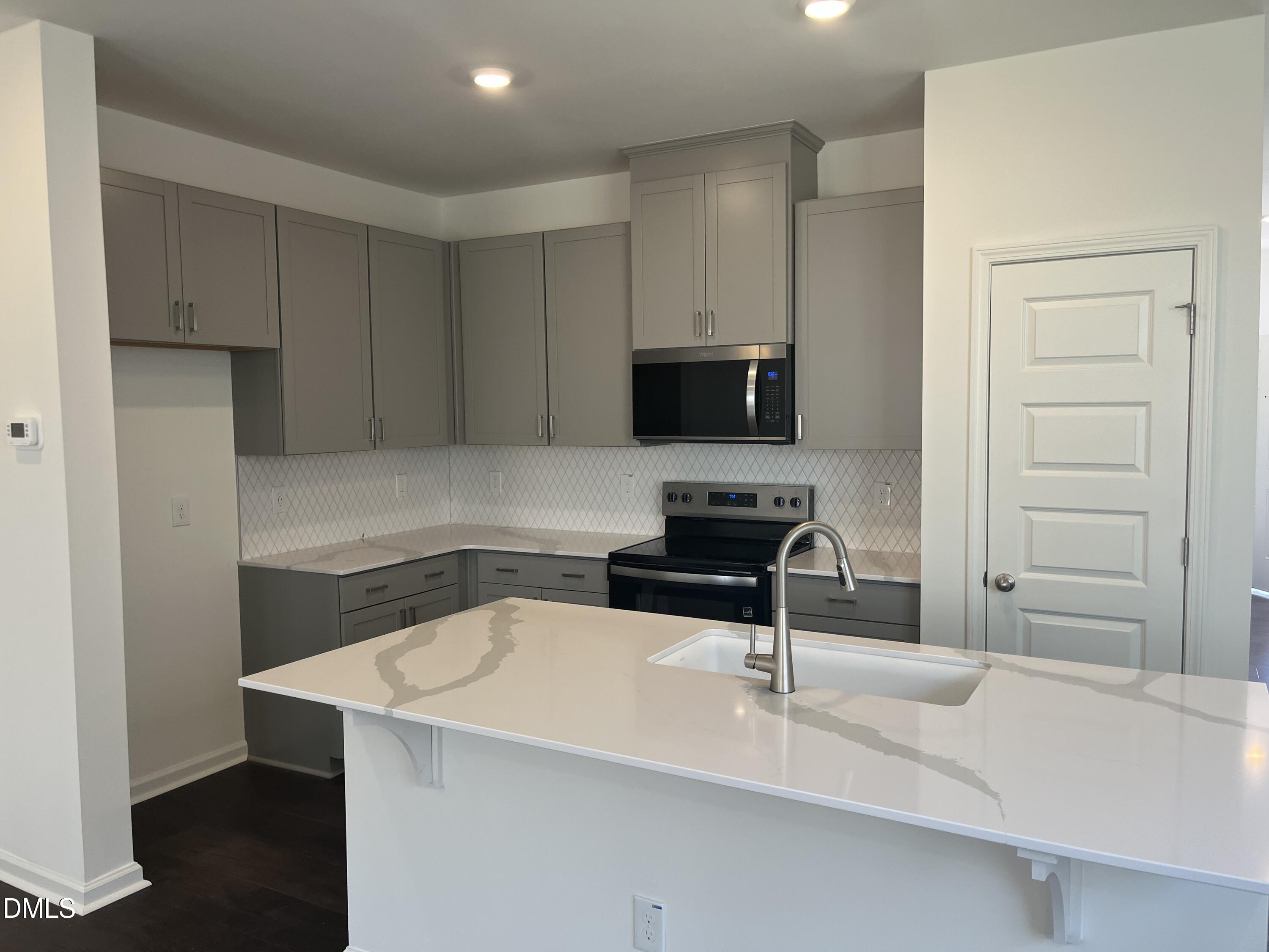 3009 Chrys Street Durham, NC 27704 - Photo 2 of 12 a kitchen with a sink cabinets and appliances