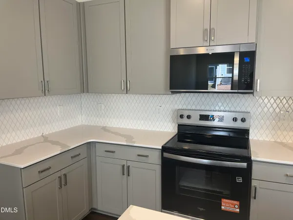 a kitchen with a stove and a microwave