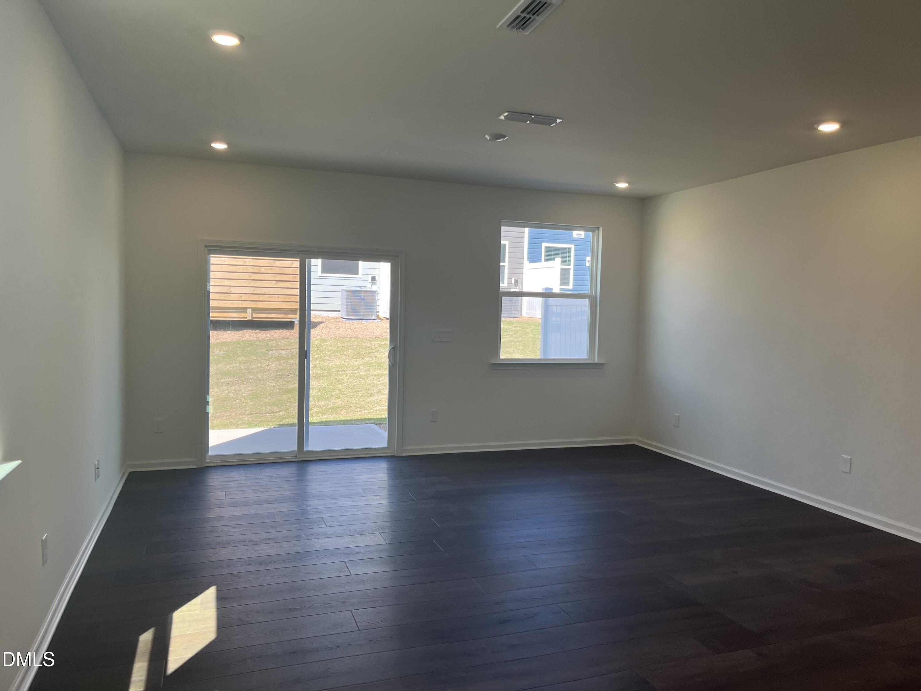 3009 Chrys Street Durham, NC 27704 - Photo 5 of 12 a view of an empty room with wooden floor and a window
