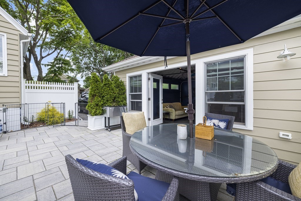 1 Auburndale Road Marblehead, MA 01945 - Photo 25 of 29 a view of a patio with a table and chairs under an umbrella