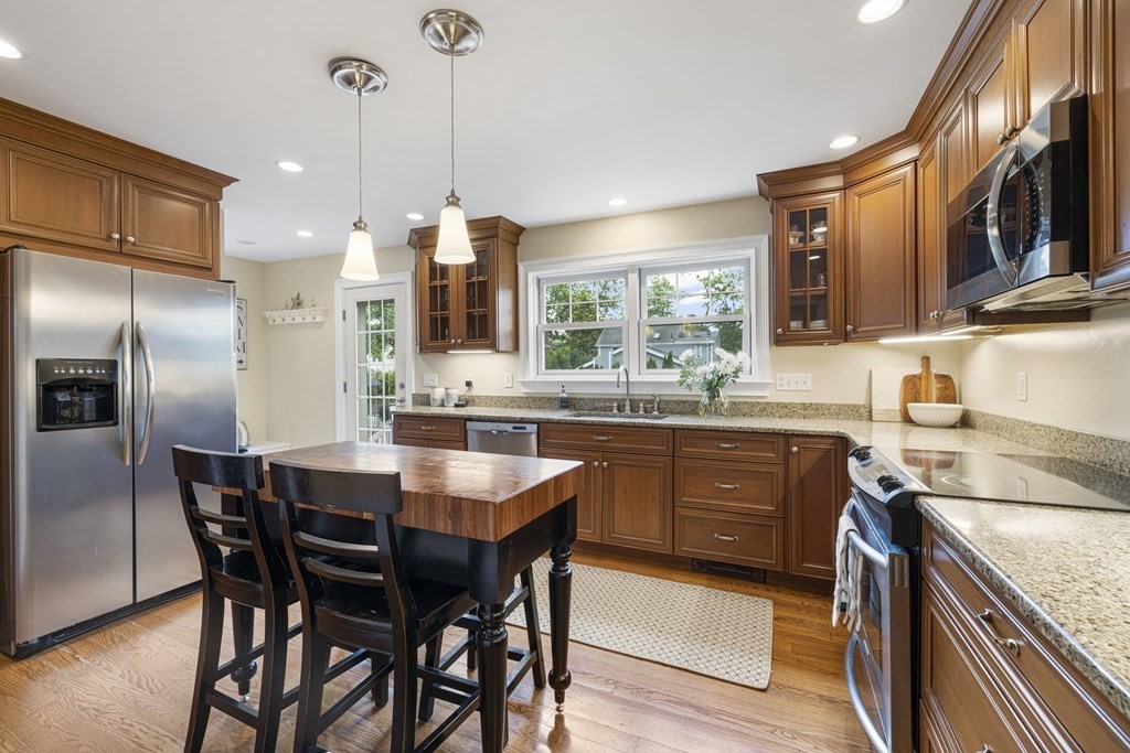 1 Auburndale Road Marblehead, MA 01945 - Photo 7 of 29 a kitchen with a table chairs refrigerator and microwave