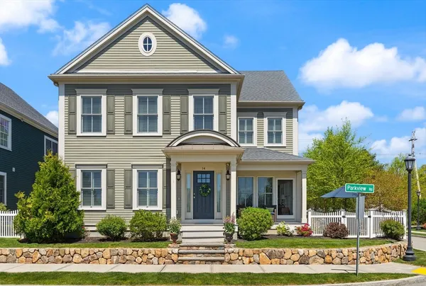 a kitchen with stainless steel appliances granite countertop a refrigerator a oven a sink a island a dining table and chairs with wooden floor