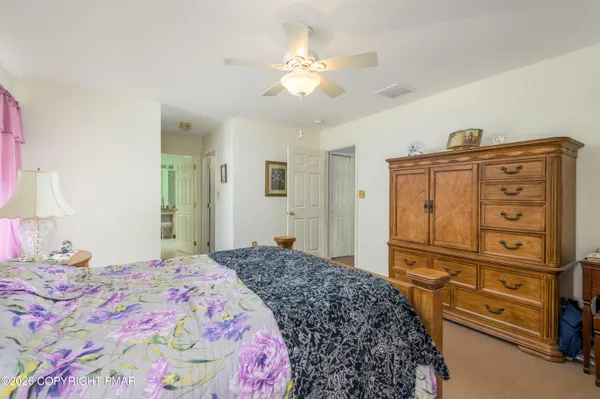a bedroom with a bed and a dresser in it