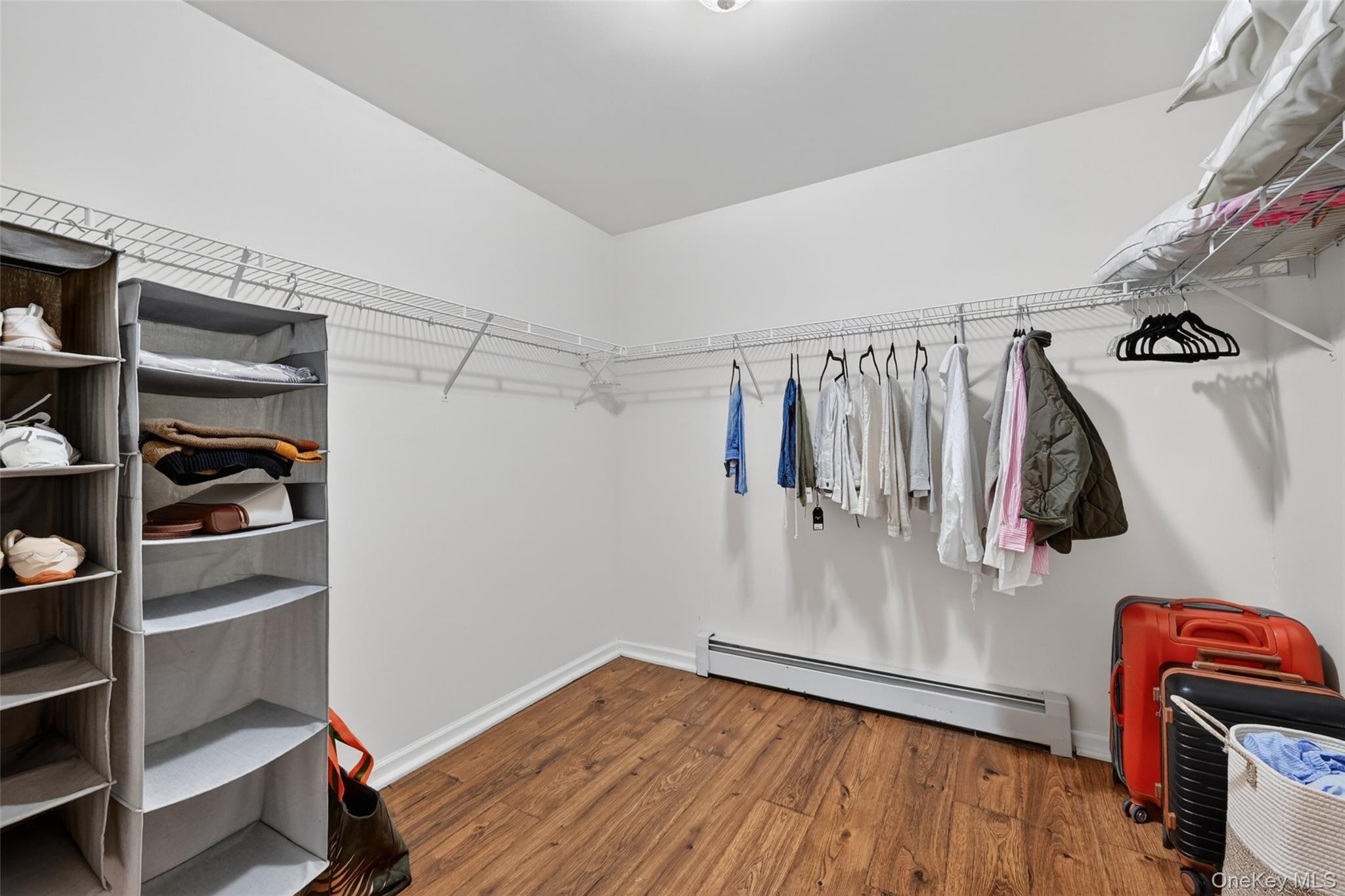 19 Bull Mine Road Chester, NY 10918 - Photo 23 of 42 Spacious walk-in closet featuring wire shelving, wire hanging rods, and wood-finish flooring