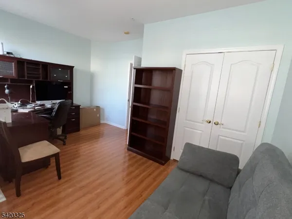 a living room with furniture and a dresser