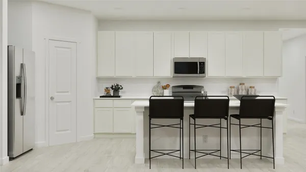 a kitchen with stainless steel appliances kitchen island granite countertop a table and chairs