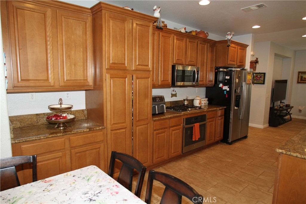 2660 West Madison Circle Anaheim, CA 92801 - Photo 19 of 52 a kitchen with stainless steel appliances granite countertop a refrigerator stove top oven and sink