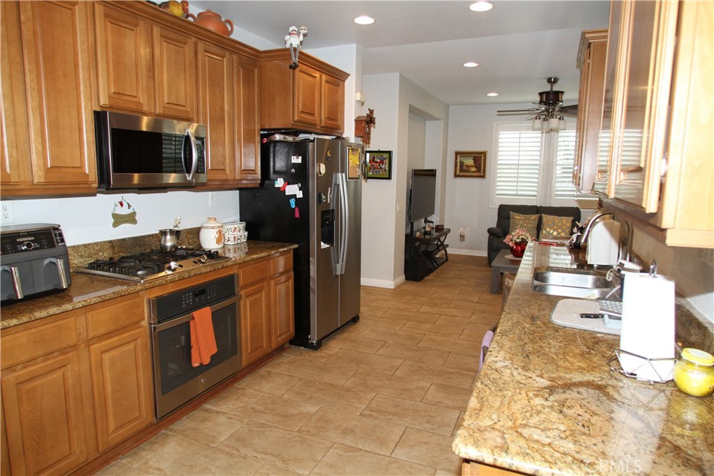 2660 West Madison Circle Anaheim, CA 92801 - Photo 20 of 52 a kitchen with stainless steel appliances granite countertop a stove refrigerator and microwave