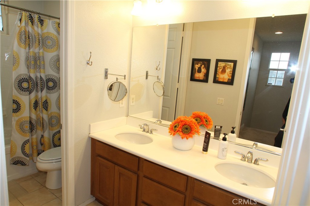 2660 West Madison Circle Anaheim, CA 92801 - Photo 35 of 52 a bathroom with a sink vanity mirror and toilet