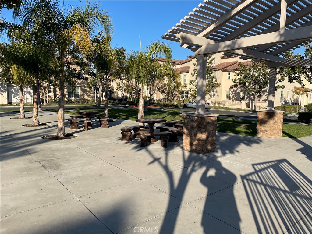 2660 West Madison Circle Anaheim, CA 92801 - Photo 44 of 52 a view of a patio with table and chairs with wooden floor and fence