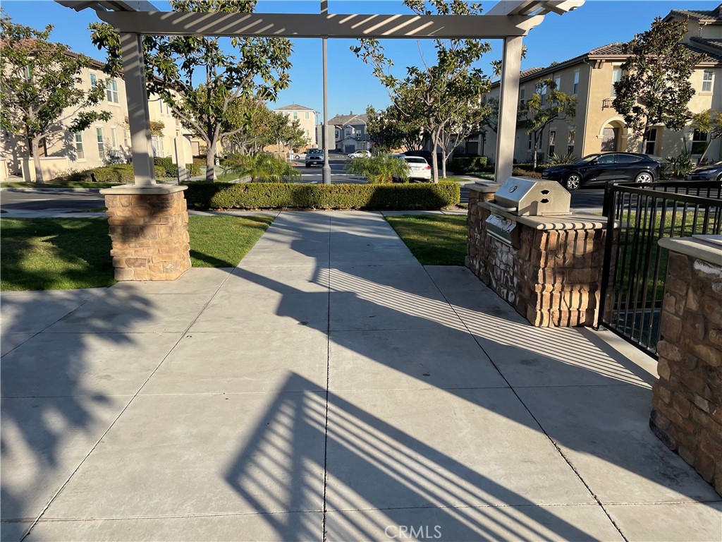 2660 West Madison Circle Anaheim, CA 92801 - Photo 45 of 52 a view of a patio with couches table and chairs with plants and trees