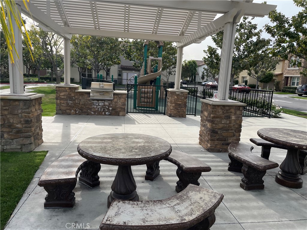 2660 West Madison Circle Anaheim, CA 92801 - Photo 48 of 52 a view of a patio with table and chairs potted plants and floor to ceiling window
