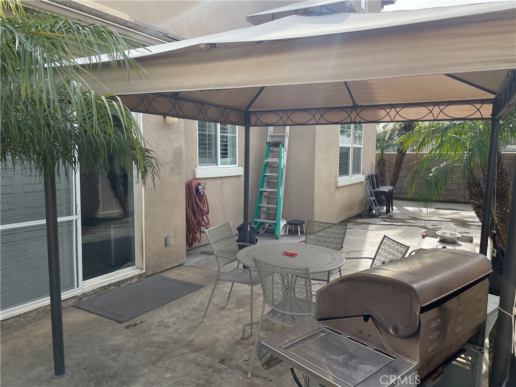 2660 West Madison Circle Anaheim, CA 92801 - Photo 9 of 52 a outdoor space with furniture and umbrella