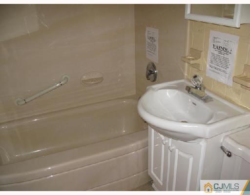 21 Piedmont Road Edison, NJ 08817 - Photo 4 of 6 a bathroom with a sink and a bathtub
