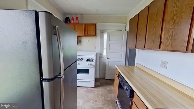 a kitchen with stainless steel appliances a refrigerator and a stove
