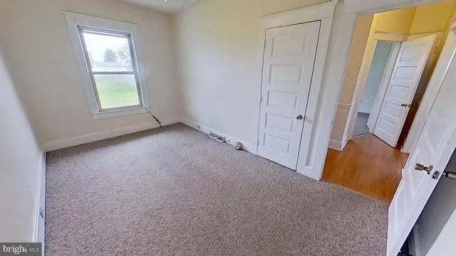 a view of an empty room and a window