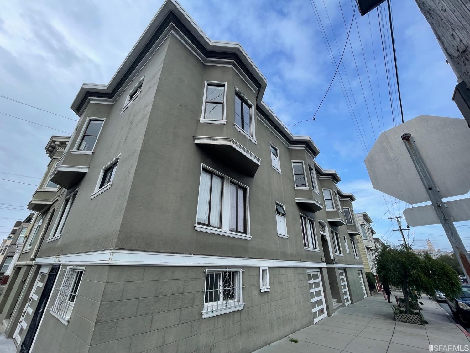 a front view of a house with plants