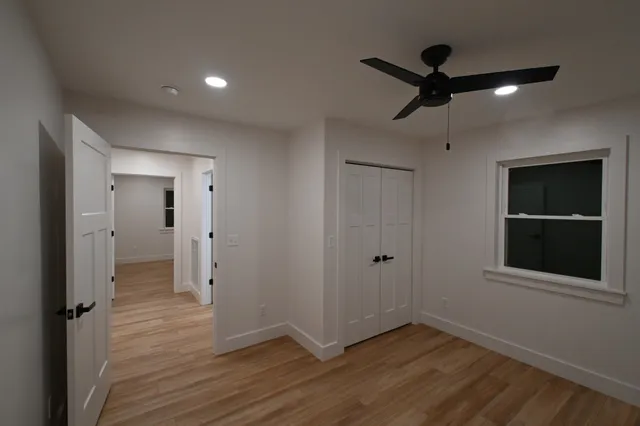 wooden floor in an empty room with a window