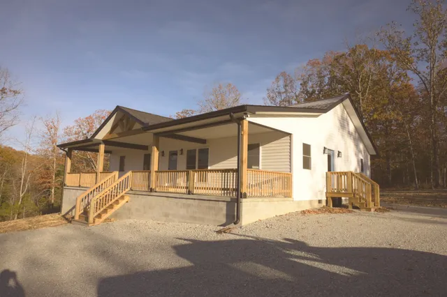 a view of a house with a wooden fence