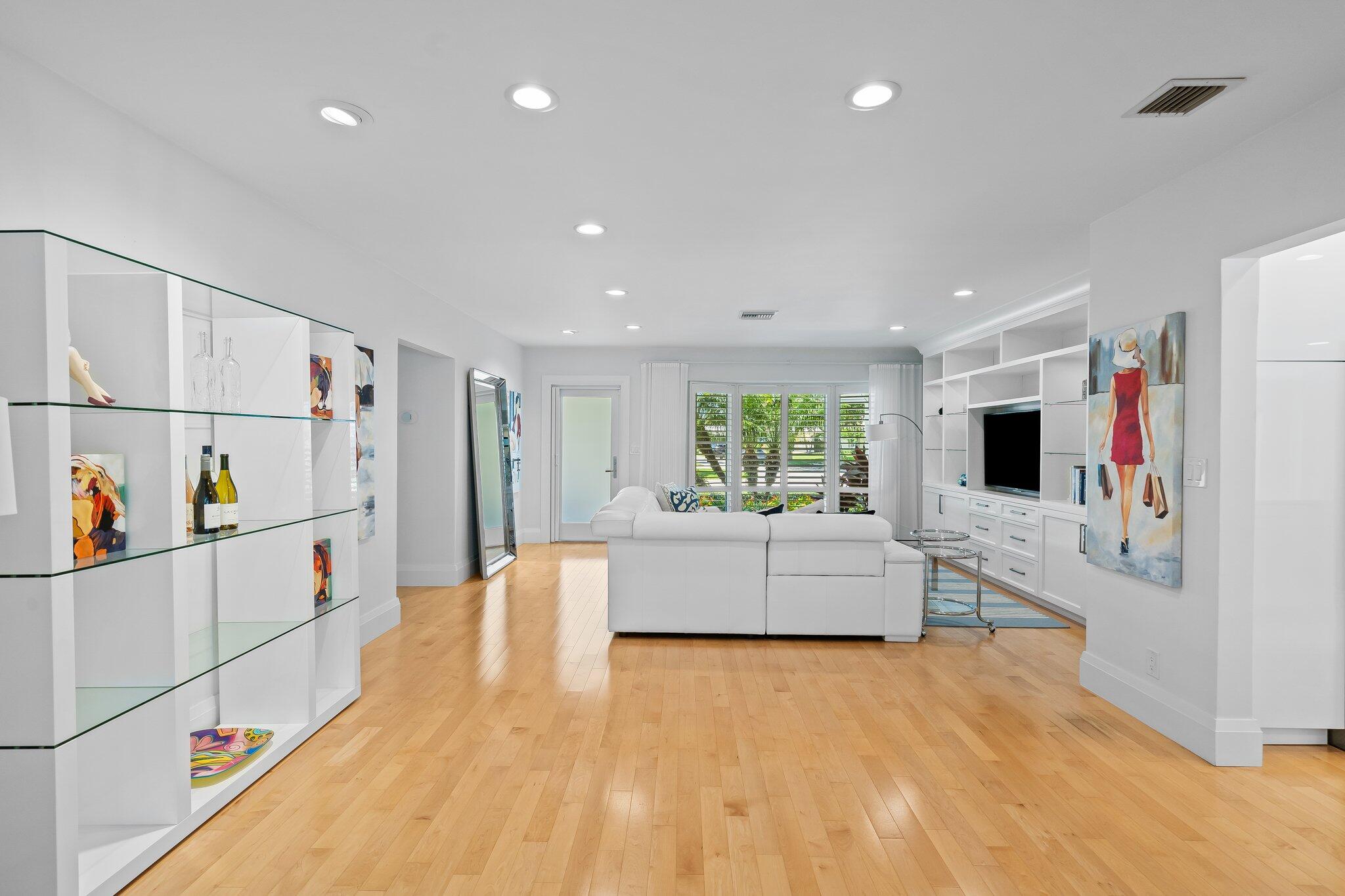 1090 Cypress Way Boca Raton, FL 33486 - Photo 15 of 40 a large white room with stainless steel appliances kitchen island a flat screen tv and a refrigerator