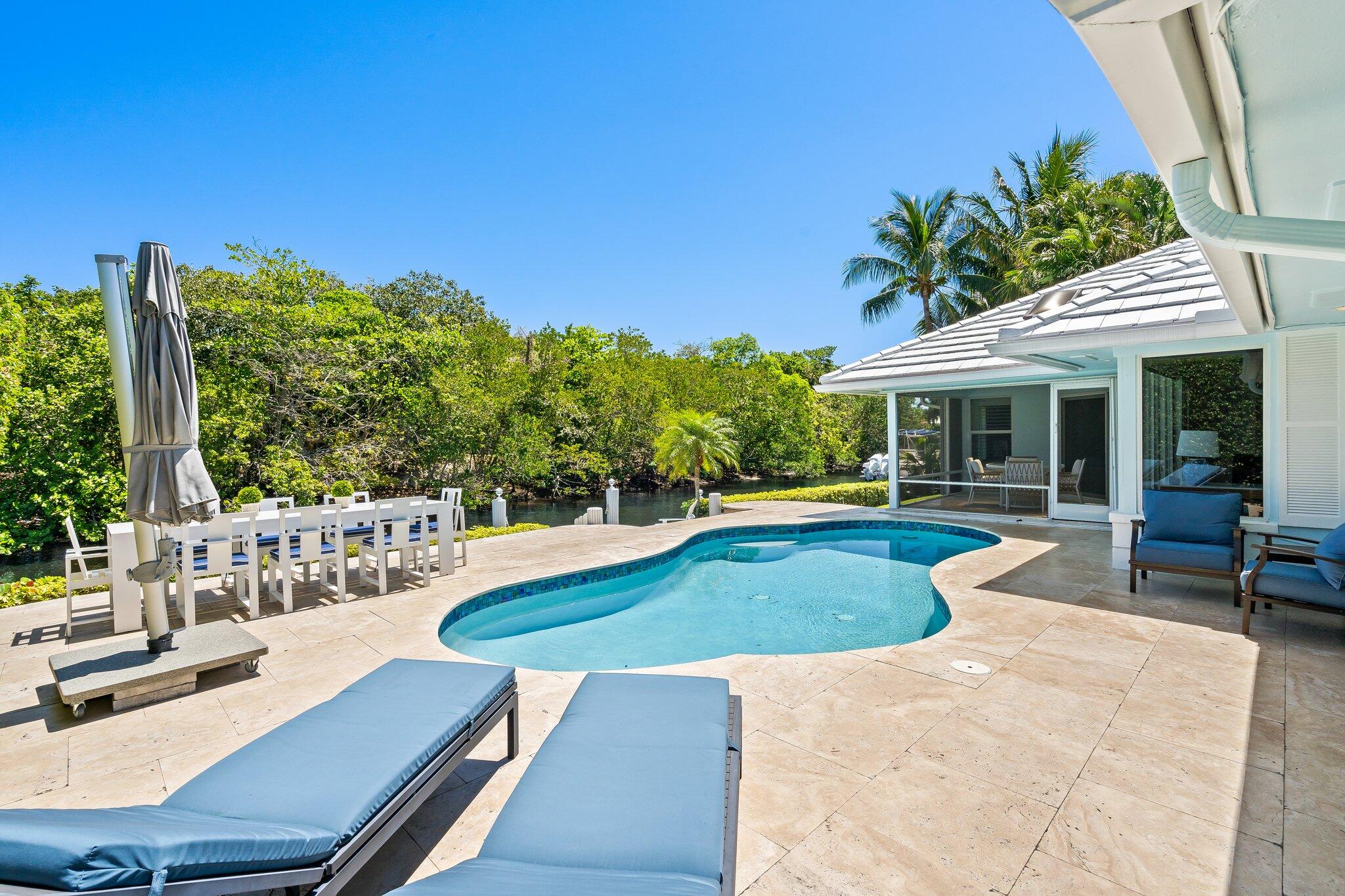 1090 Cypress Way Boca Raton, FL 33486 - Photo 2 of 40 a view of a house with swimming pool and sitting area