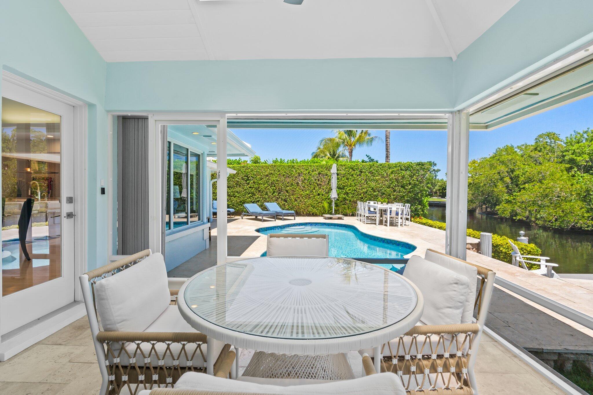 1090 Cypress Way Boca Raton, FL 33486 - Photo 30 of 40 a dining room with furniture a rug and a large window