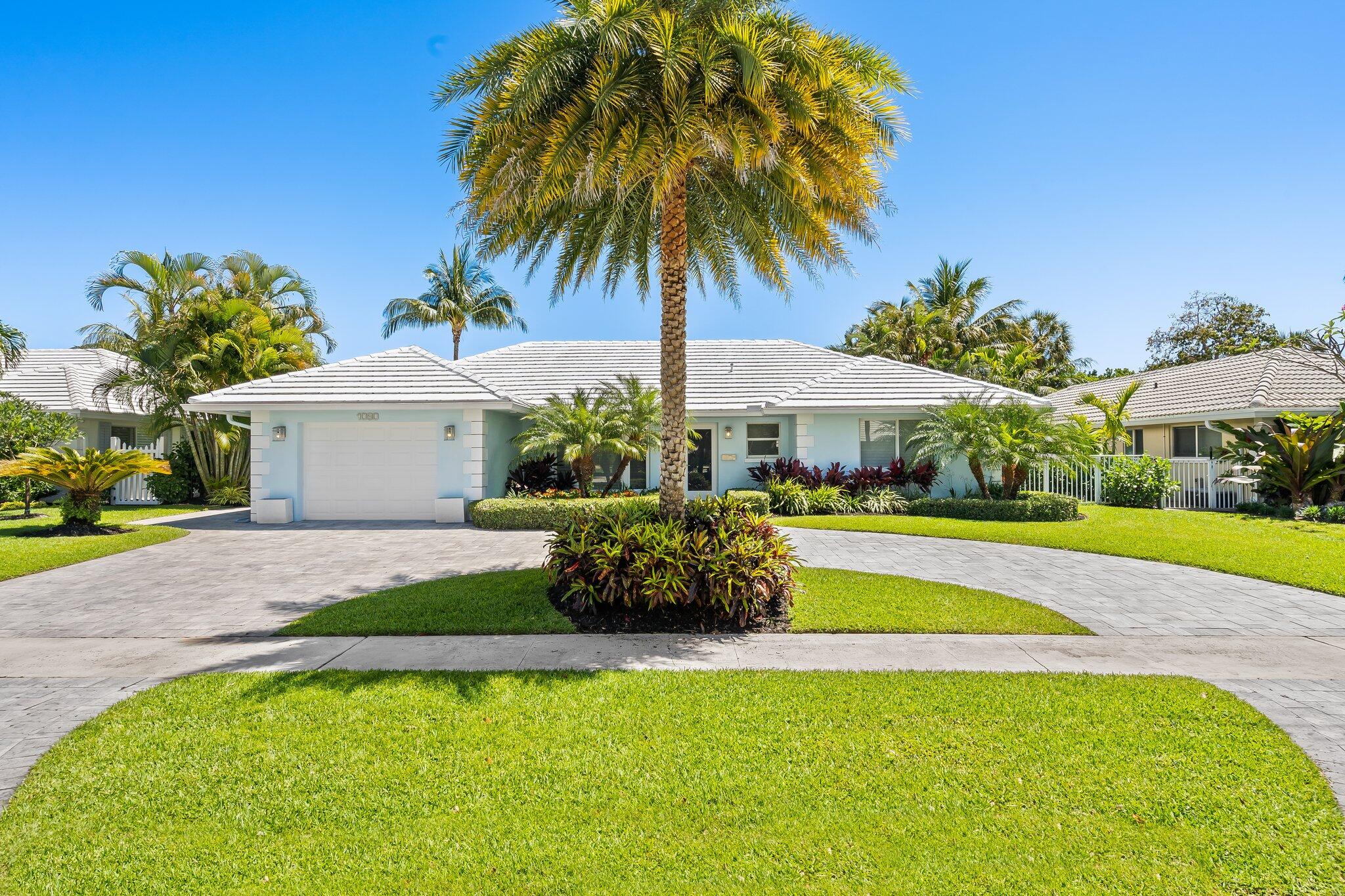 1090 Cypress Way Boca Raton, FL 33486 - Photo 3 of 40 a front view of a house with swimming pool having outdoor seating