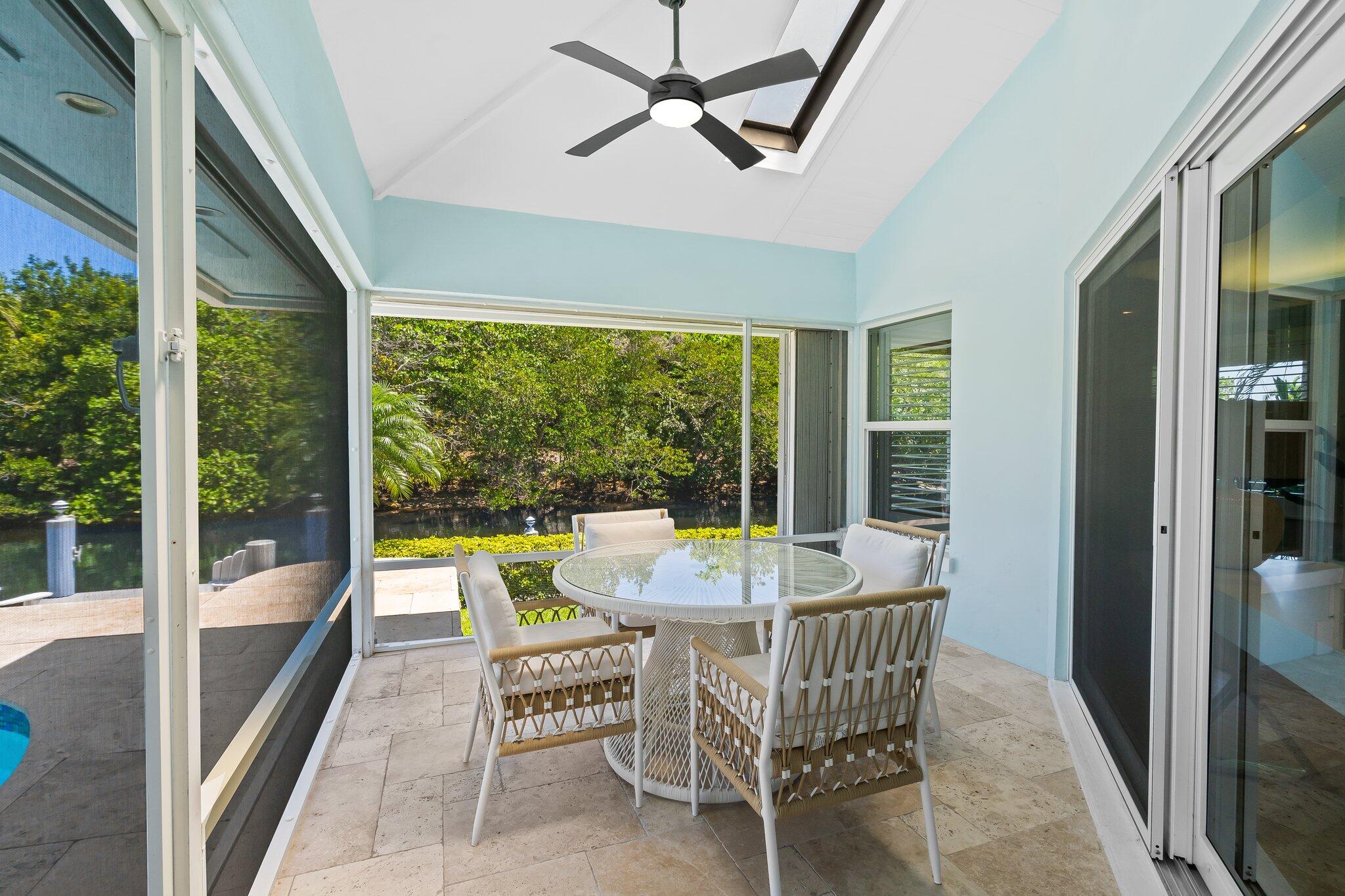 1090 Cypress Way Boca Raton, FL 33486 - Photo 31 of 40 a dining room with furniture a chandelier and glass door
