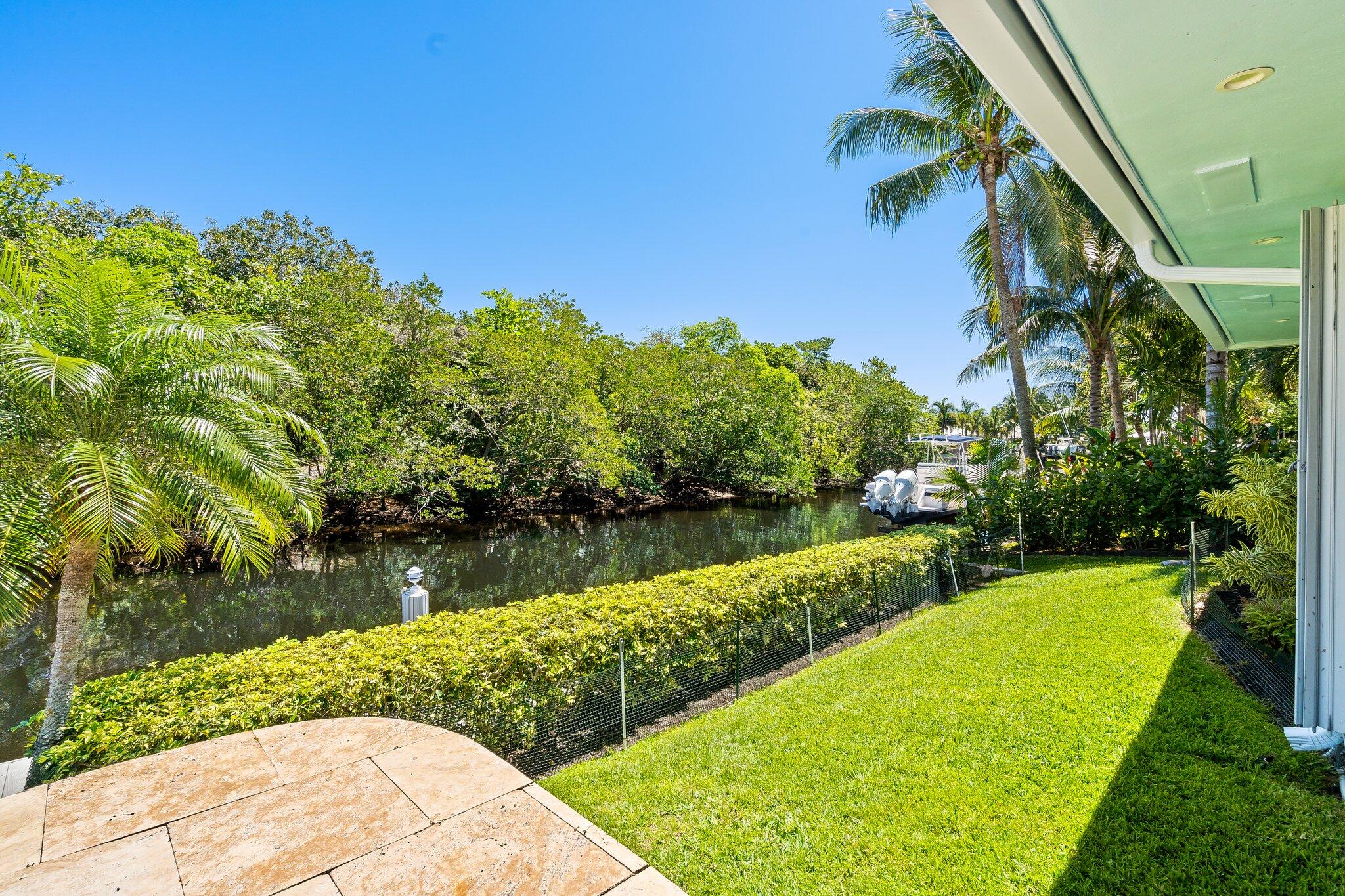 1090 Cypress Way Boca Raton, FL 33486 - Photo 32 of 40 a view of a lake with a yard