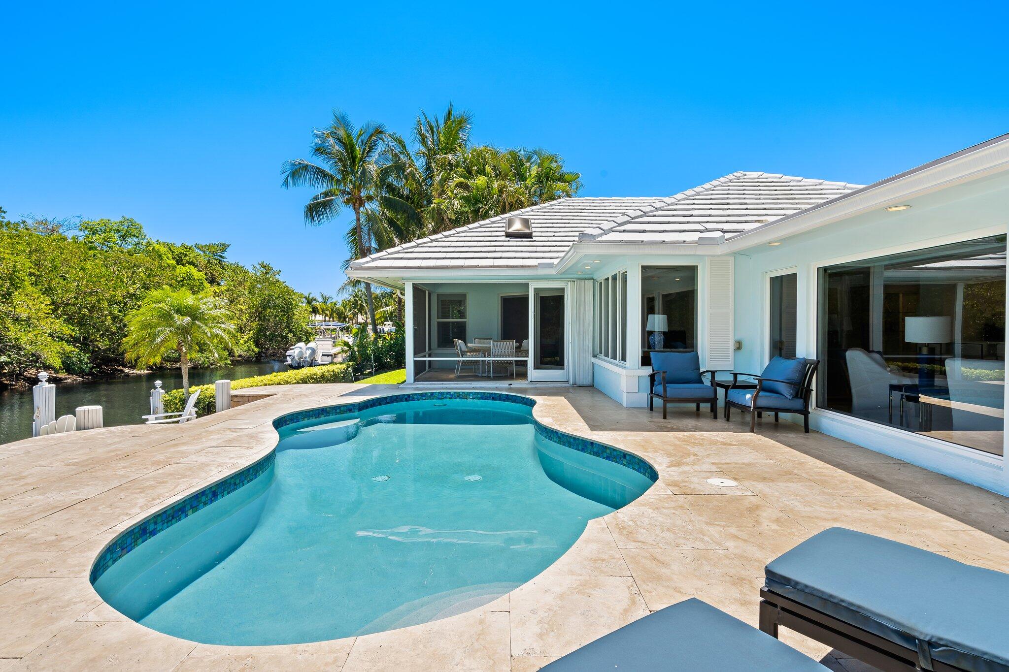 1090 Cypress Way Boca Raton, FL 33486 - Photo 37 of 40 a view of a house with swimming pool and porch
