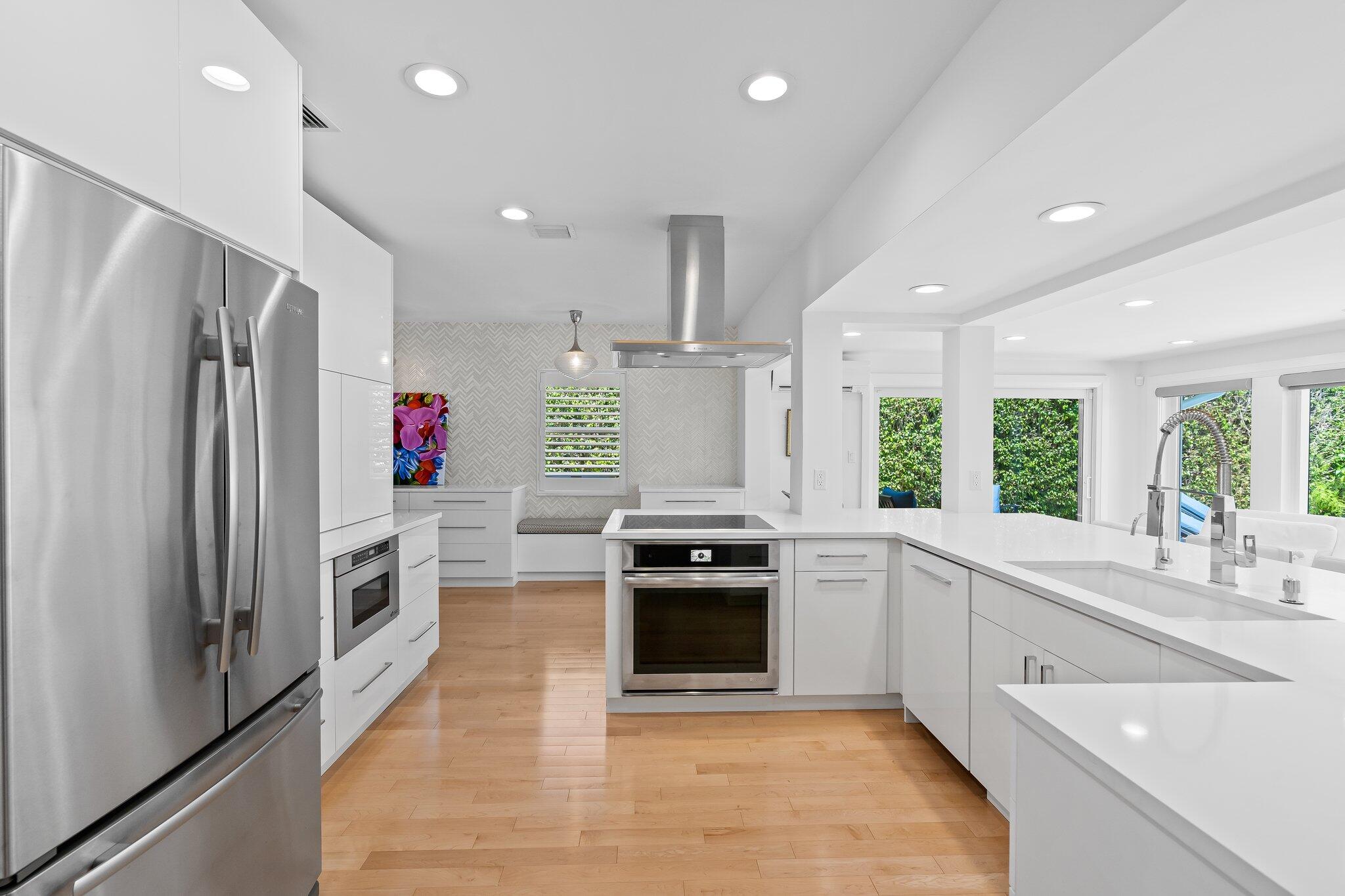 1090 Cypress Way Boca Raton, FL 33486 - Photo 9 of 40 a kitchen with stainless steel appliances granite countertop a stove and a refrigerator