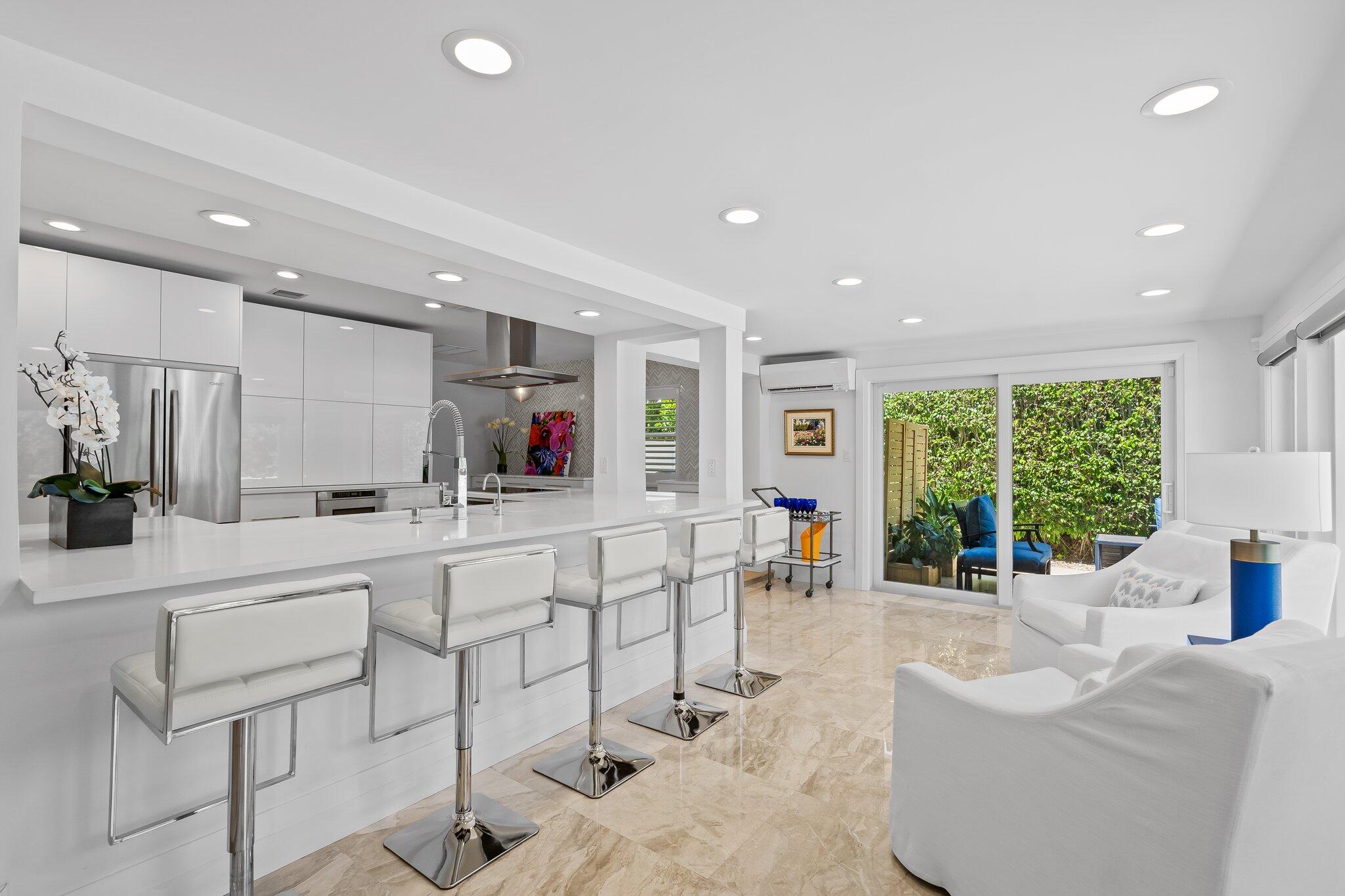 1090 Cypress Way Boca Raton, FL 33486 - Photo 10 of 40 a large living room with stainless steel appliances furniture a large window and a sink