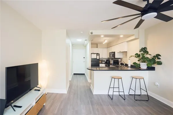 a kitchen with stainless steel appliances granite countertop a refrigerator a sink and a stove