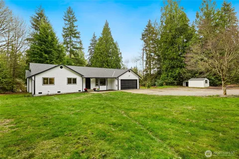 a kitchen with stainless steel appliances granite countertop a refrigerator a sink dishwasher a stove with white countertops with wooden floor