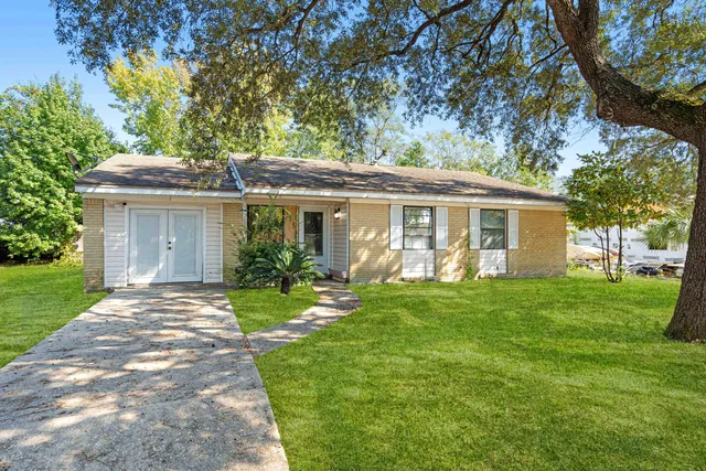 a front view of a house with a garden