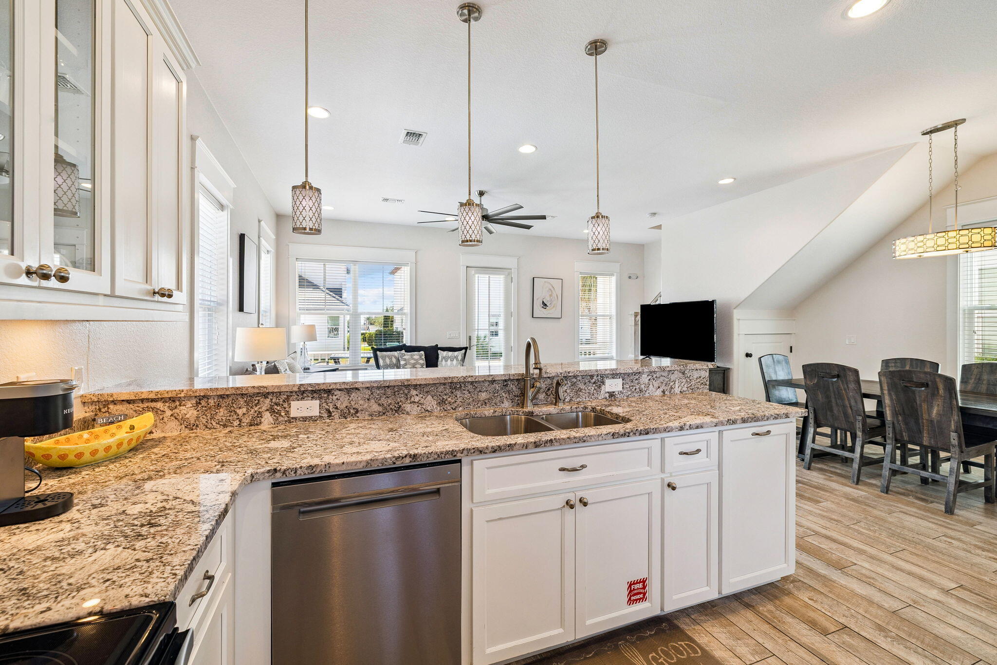 32 Moonlit Shores Lane Santa Rosa Beach, FL 32459 - Photo 14 of 48 a kitchen with kitchen island granite countertop a sink a counter top space and living room view