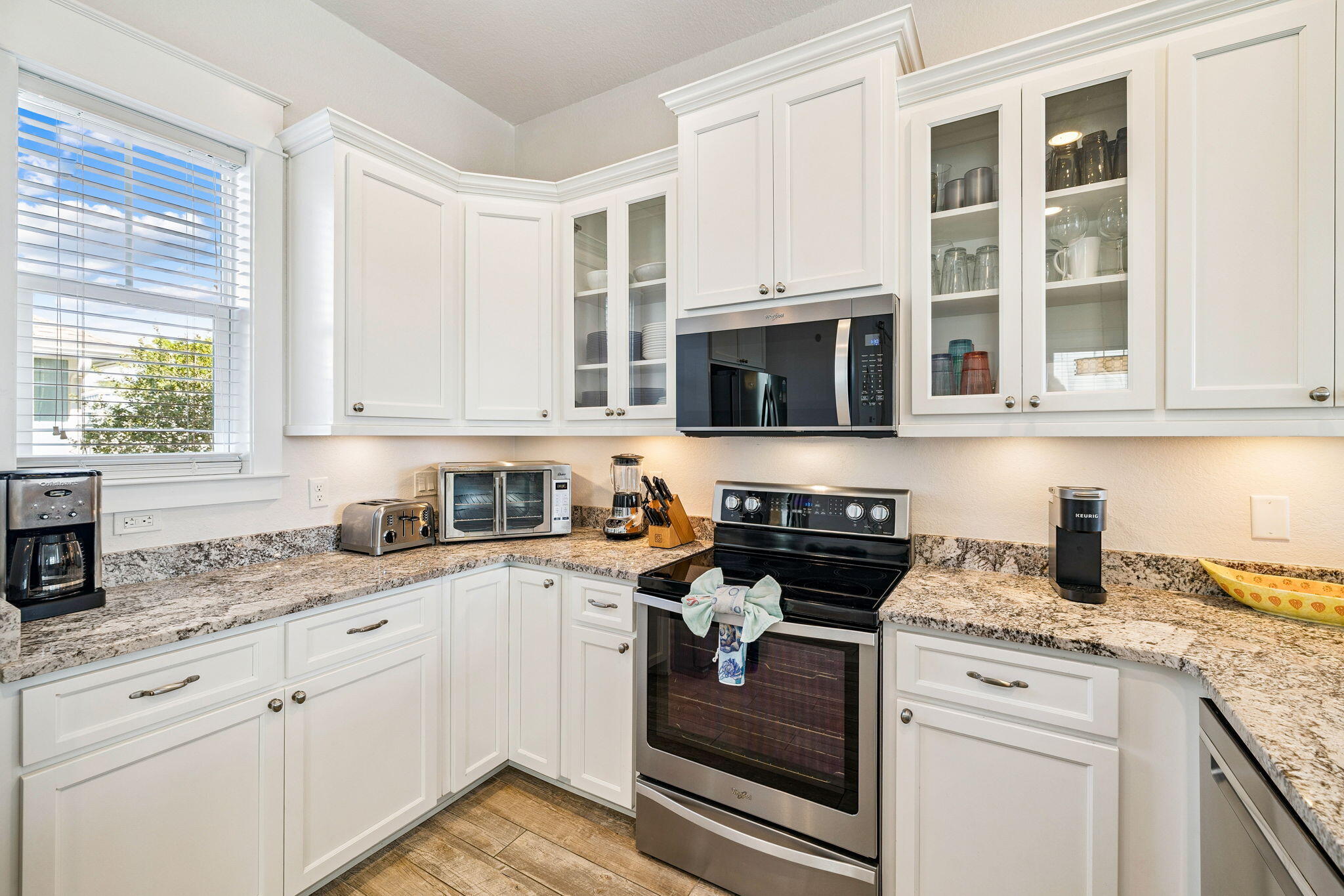 32 Moonlit Shores Lane Santa Rosa Beach, FL 32459 - Photo 15 of 48 a kitchen with stainless steel appliances granite countertop white cabinets and a stove top oven